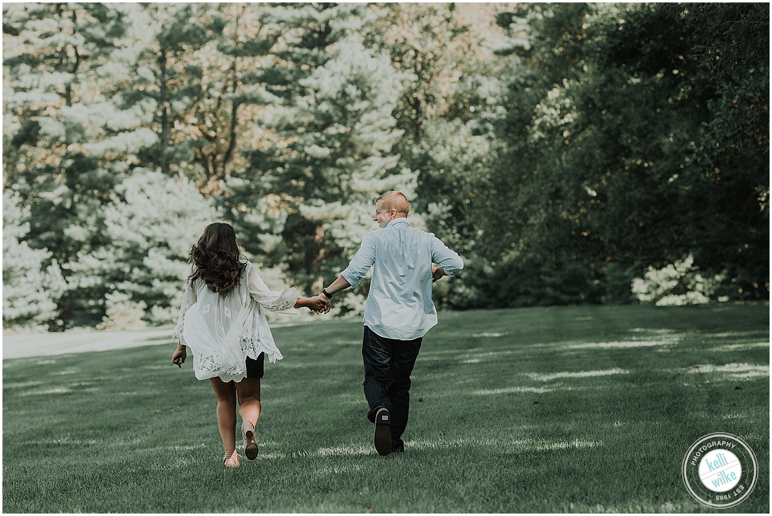 engagement photography walking through a field