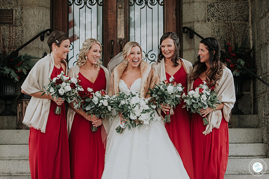 christmas wedding at the whist club portrait of bridesmaids wearing red and shawls with red and white flowers by yukie in delaware