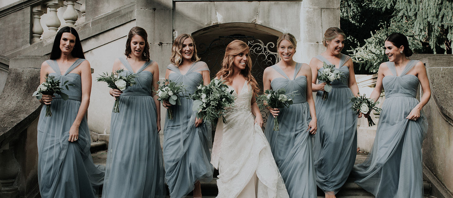 bridesmaids walk down the staircase at winterthur gardens