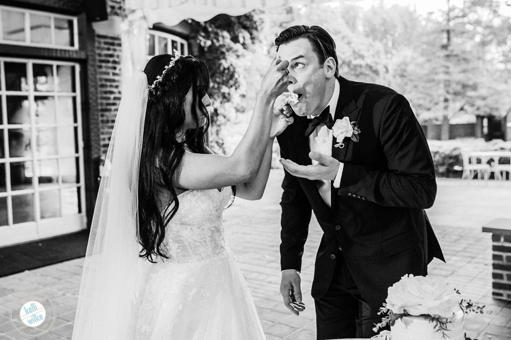 Bride feeds the groom cake at Greenville Country Club, she is wearing a Lazaro wedding dress from Jennifer's bridal. The cake was made by Michelle Mitchell Pastry Designs