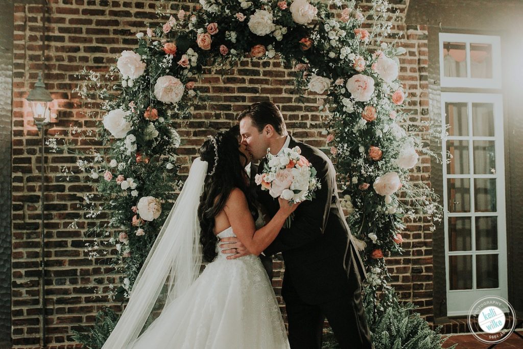 Couple kisses at their wedding ceremony at Greenville Country Club in Greenville, DE