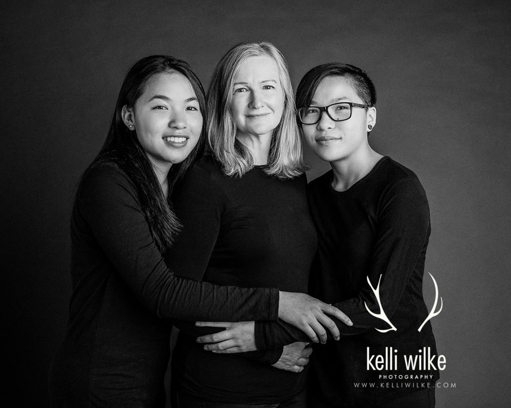 mother and her twin daughters black and white portrait