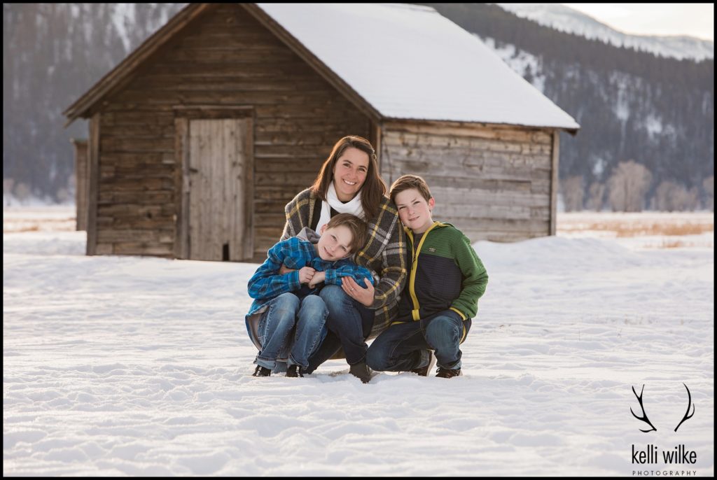 mother and her sons sit for a photo at Mormon Row for their family portraits