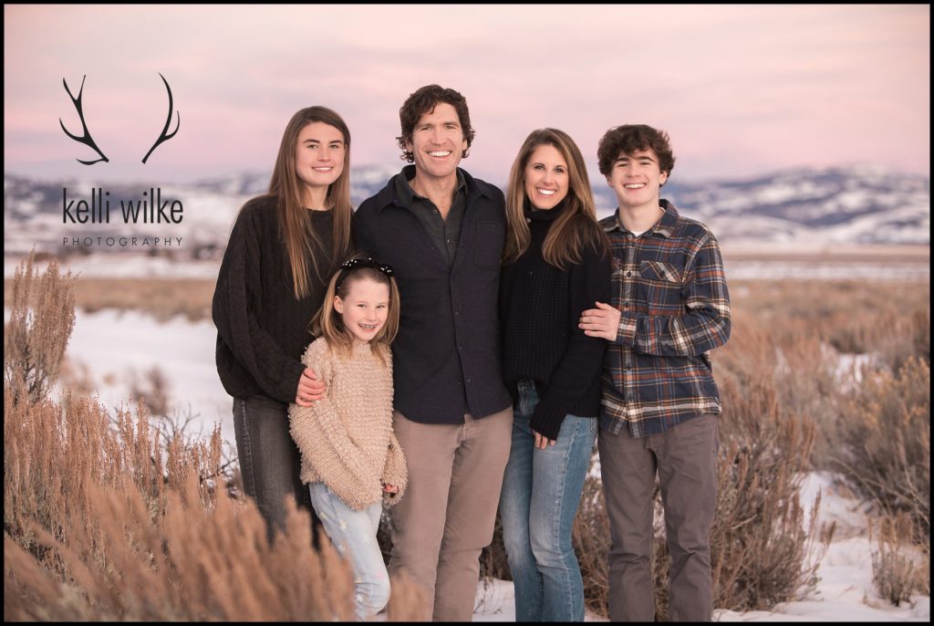 Family portrait at sunset in Jackson Wyoming with the pink sky