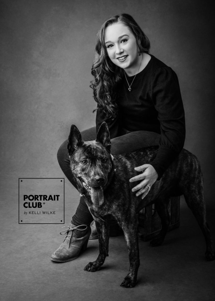 A portrait of a young woman and her dog. 