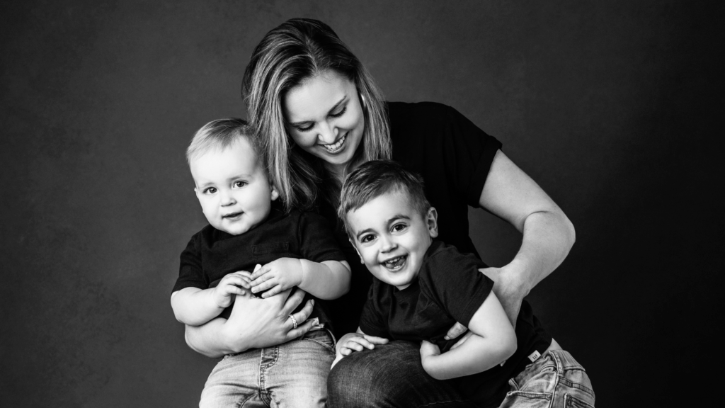Black and white family portrait in studio by family photographer