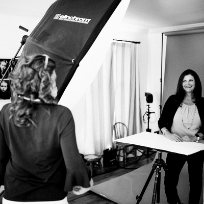 Studio photographer at work with client during family portrait session
